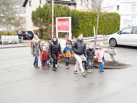 Kinder schmücken einen Weihnachtsbaum im Supermarkt.